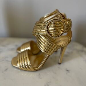 BRAND NEW. Michael Kors gold heels.